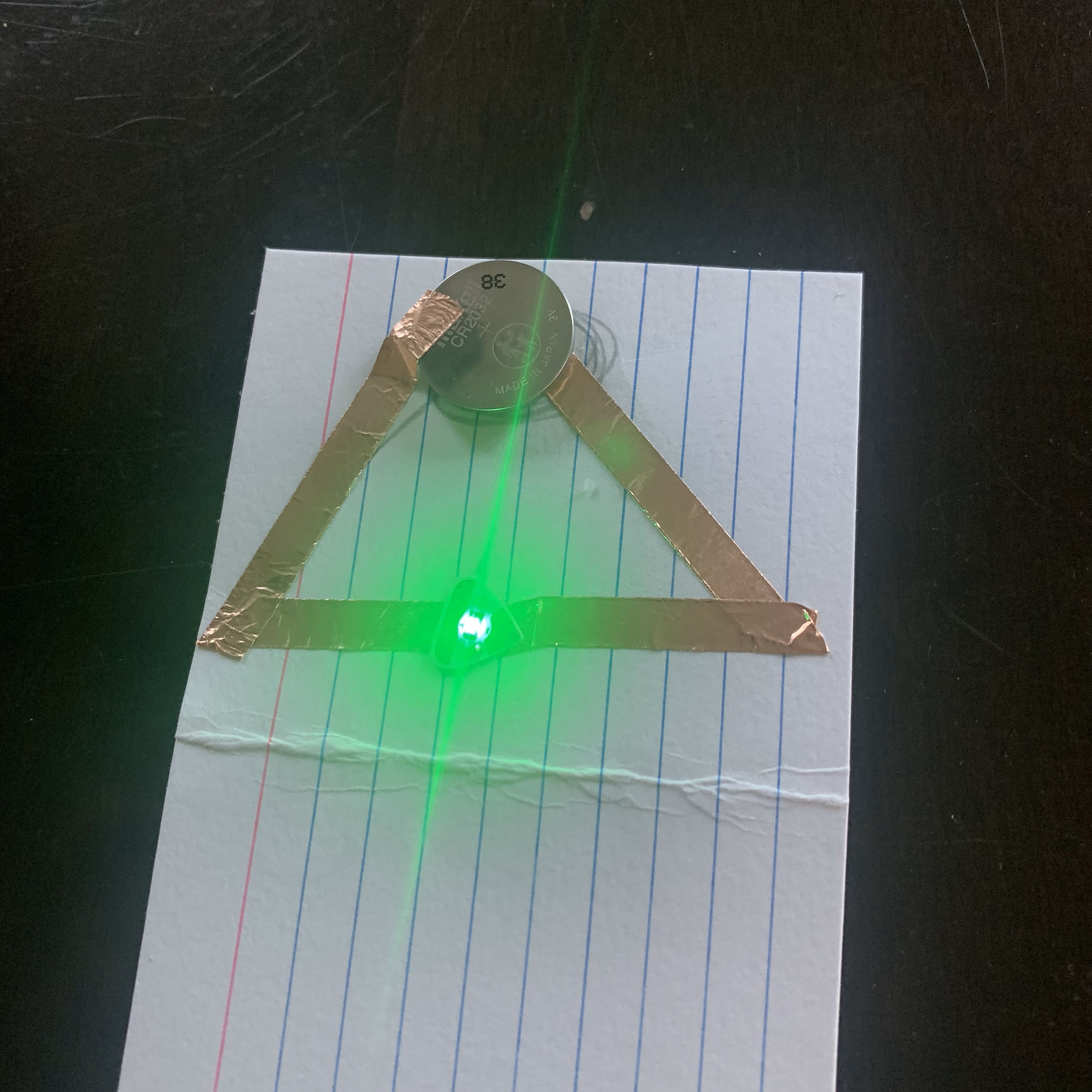 Test of the triangle shaped circuit is a success via the LED Light being activated.