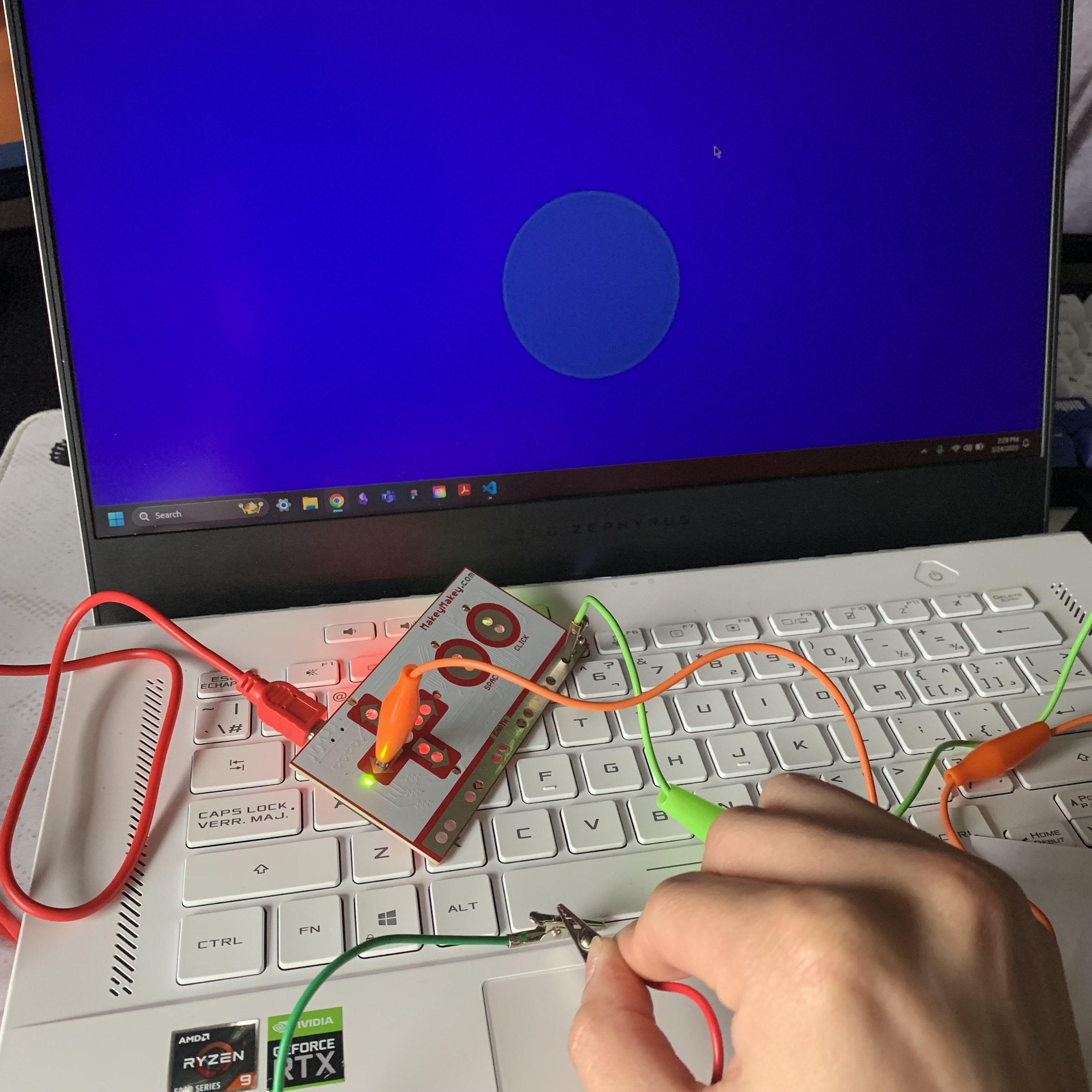 Testing extending connection using drawn lines of graphite paper and more alligator clips and making contact with each other completing the circuit.