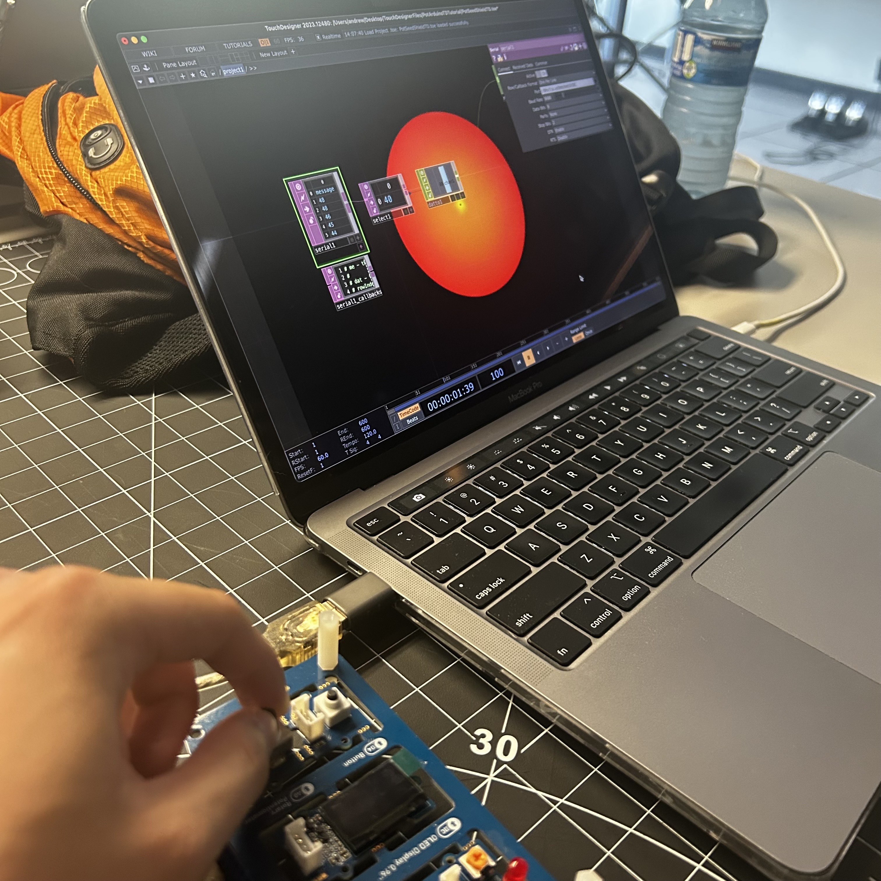 A photo of me testing the connection between the user and the Arduino to make the sphere on the screen change size via the dial on the Arduino.