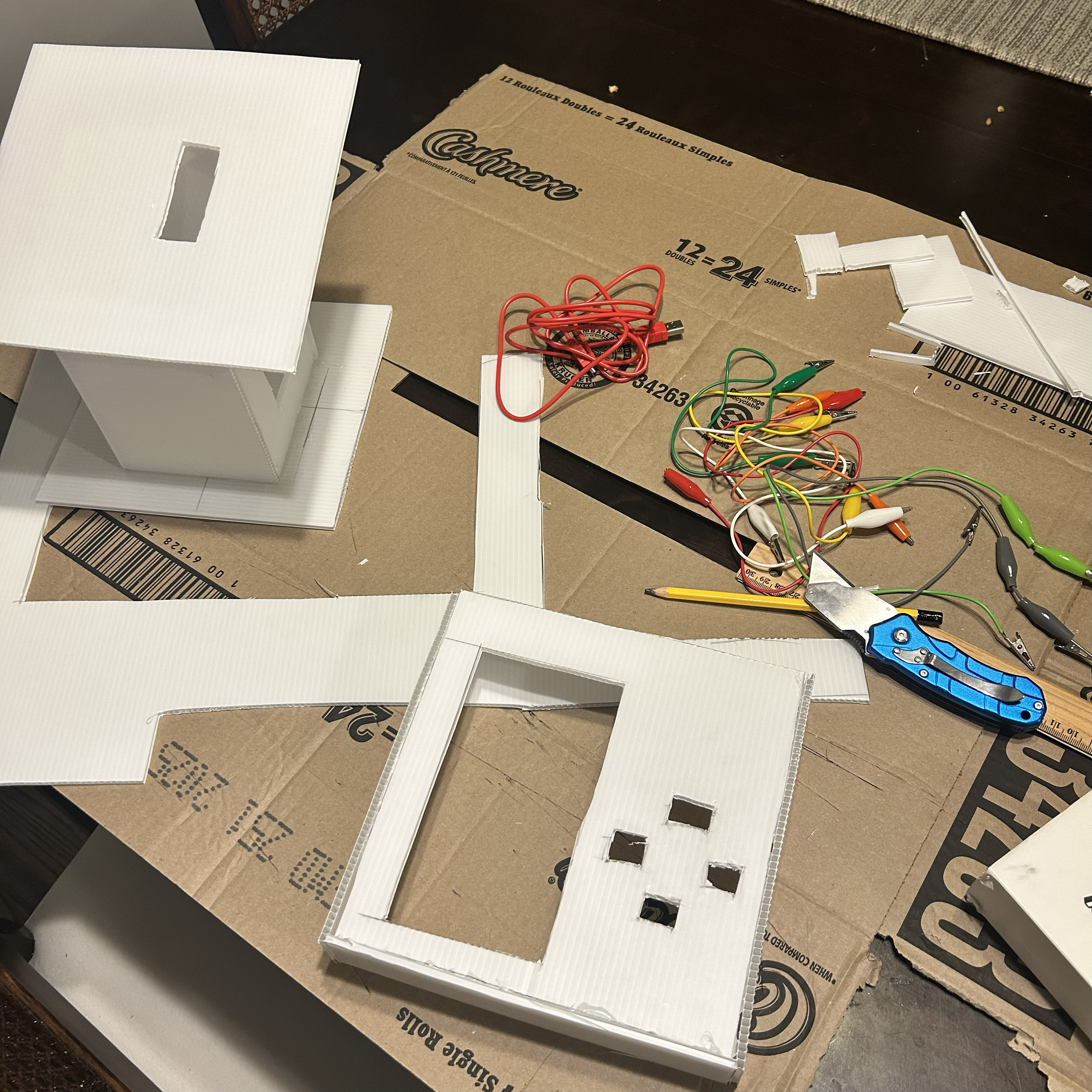 Attaching the wires to the buttons and top part of the first kiosk.