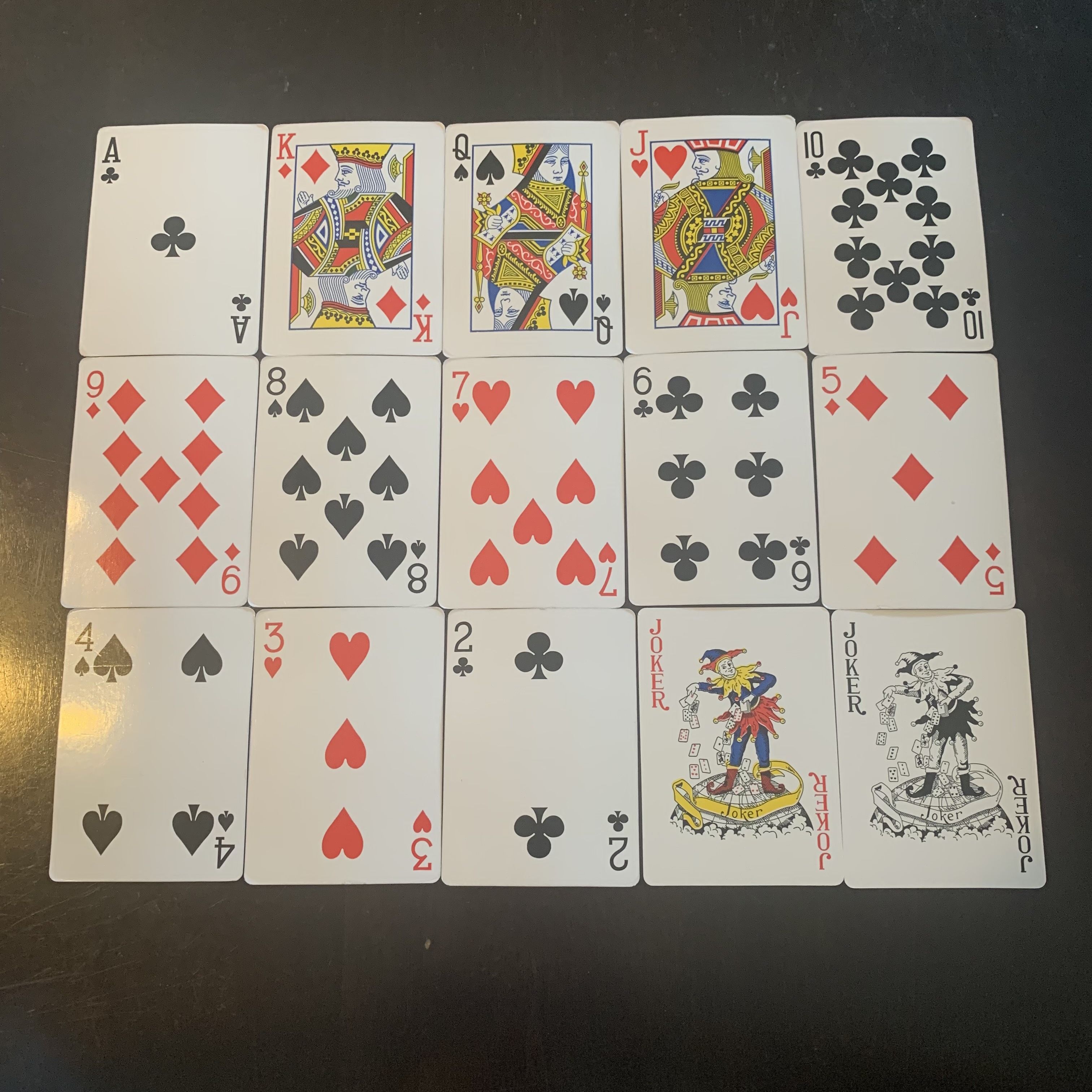 A pattern of playing cards with their suits.